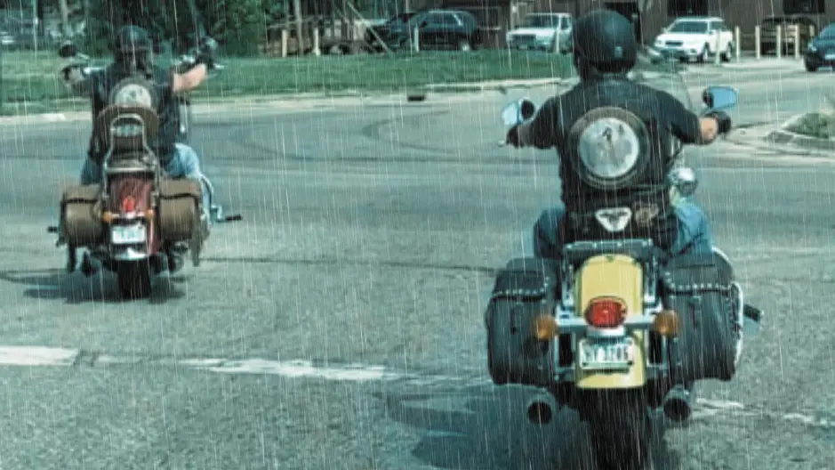 Two motorcyclists, Dan Matzdorff and Pete Leehey, demonstrate how to ride at a safe distance in the rain