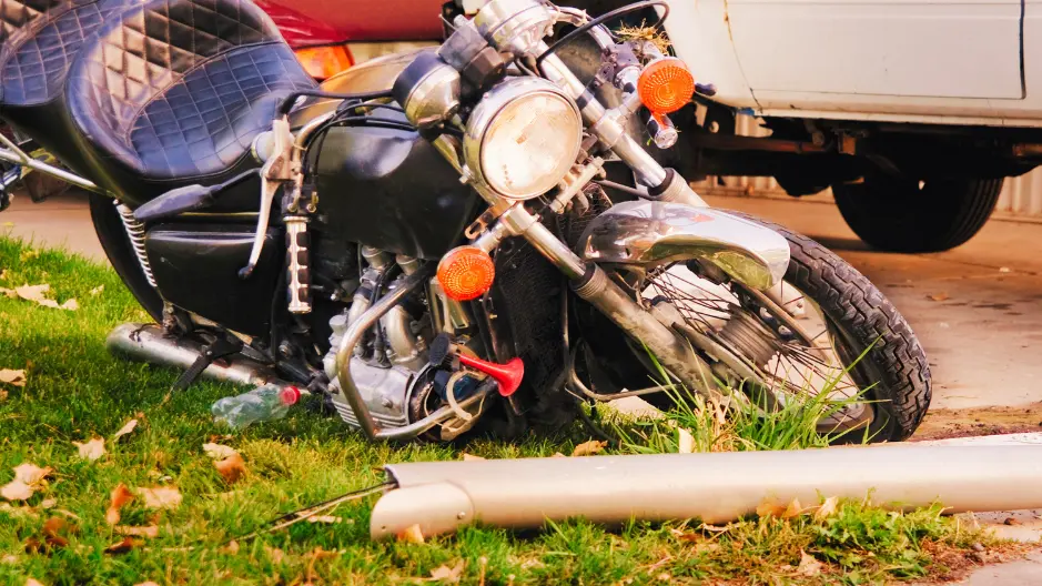 Image of a crashed motorcycle on the side of a road