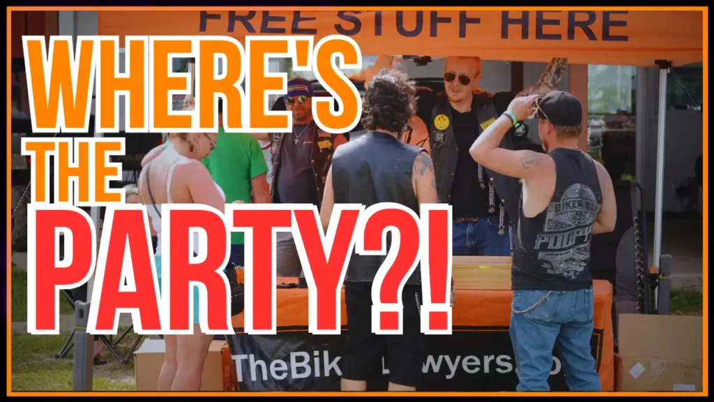 Image of The Biker Lawyers at a vendor awning with text 