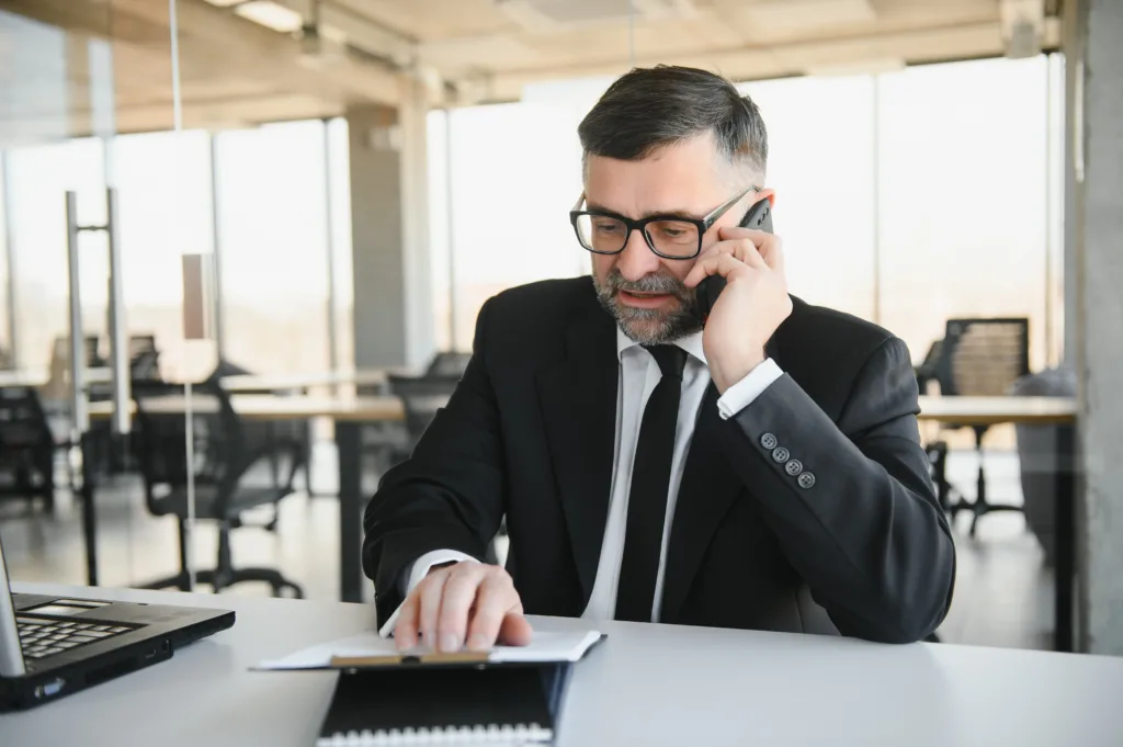image showing an insurance worker on the phone at his desk
