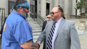 Cedar Rapids Iowa based Personal Injury Attorney Pete Leehey meets a client outside a courthouse.