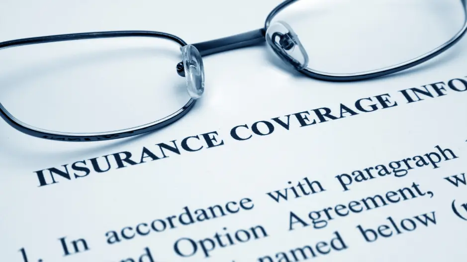 Image of glasses above an insurance policy page