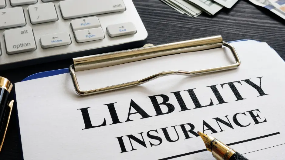 Image of paper on a clipboard with the words liability insurance printed in black ink