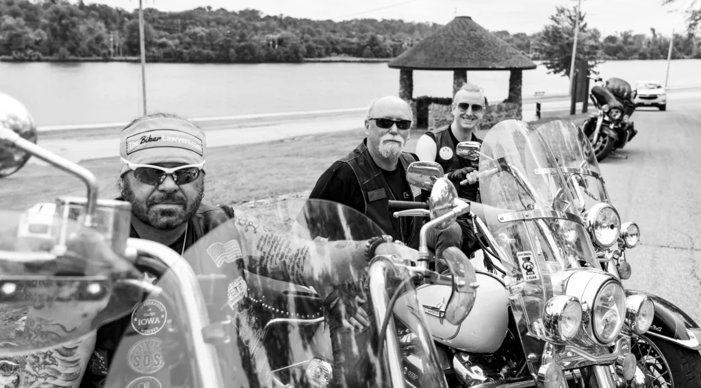 Black and white image of The Biker Lawyers- Pete Leehey, Dan Matzdorff, and Jonathan Jansen; sitting on their motorcycles.