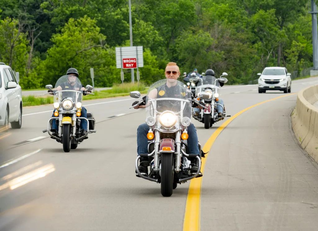 Dan Matzdorff, Jon Jansen, and Pete Leehey, The Biker Lawyers riding motorcycles on a highway