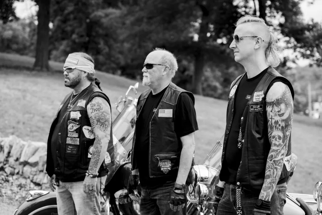 Black and white image of The Biker Lawyers, Pete Leehey, Dan Matzdorff, and Jon Jansen