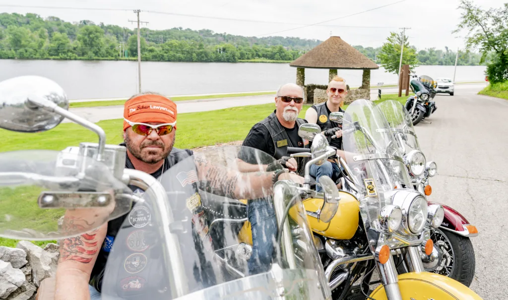 The Biker Lawyers, Motorcycle Accident Lawyers, sit on their motorcycles.