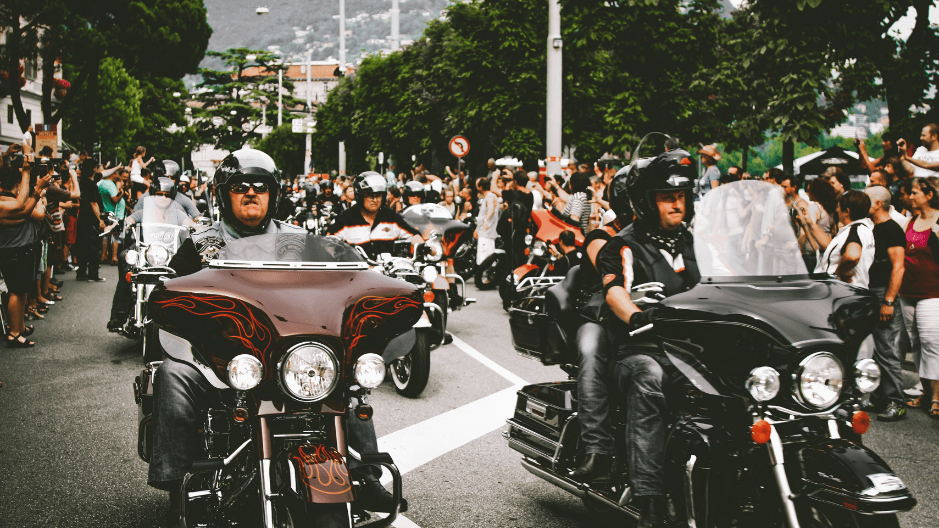 Many people on motorcycles participating in a community benefit group ride.