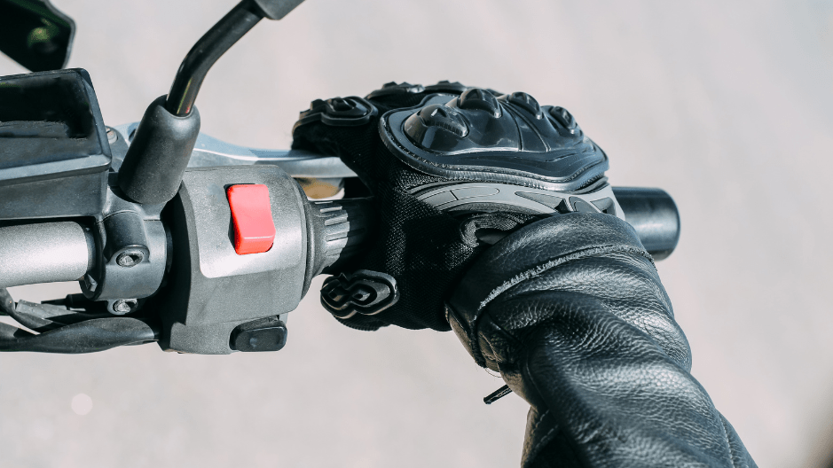 Close up image of a gloved hand on the throttle of a motorcycle