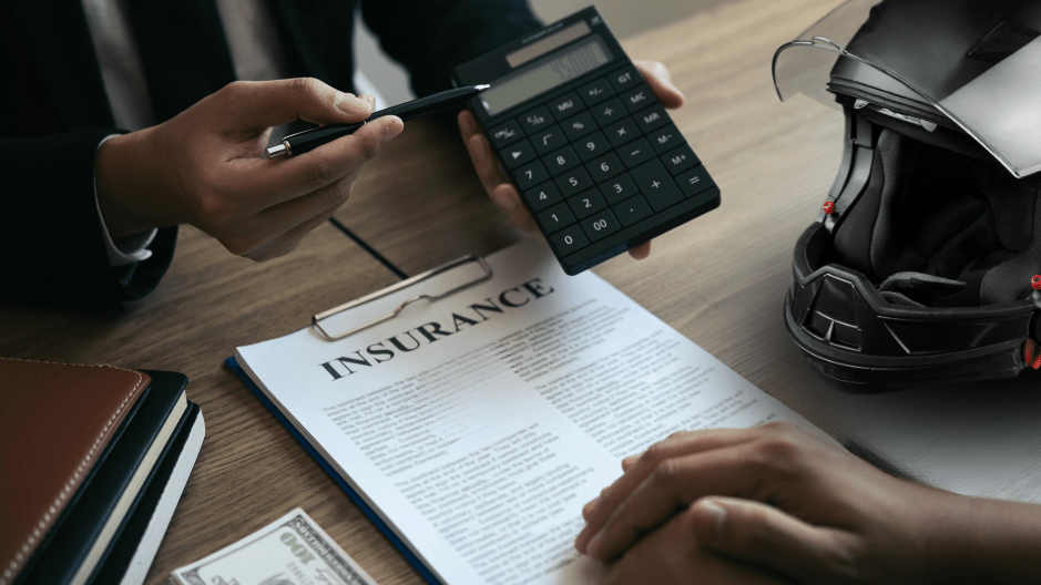 A man in a suit goes over motorcycle insurance coverage options