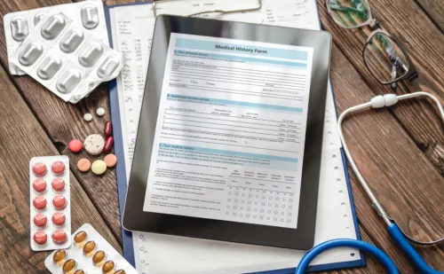 Patient medical history and medical records on a clipboard with stethoscope