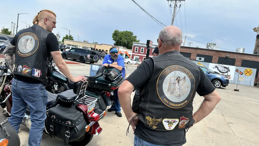 Biker Lawyers Jon Jansen and Dan Matzdorff meet with a rider at The Chrome Horse Saloon in Cedar Rapids, Iowa